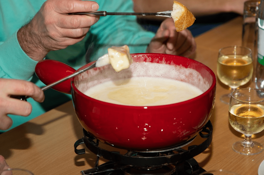 people enjoying some cheese fondue