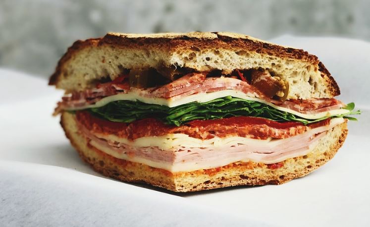 a halved ham and cheese sandwich