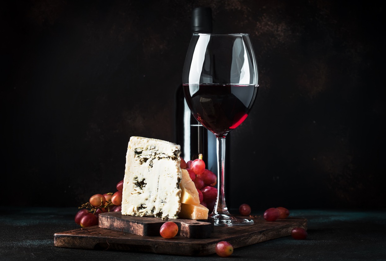 Port wine and blue cheese, still life in rustic style, vintage wooden table background, selective focus