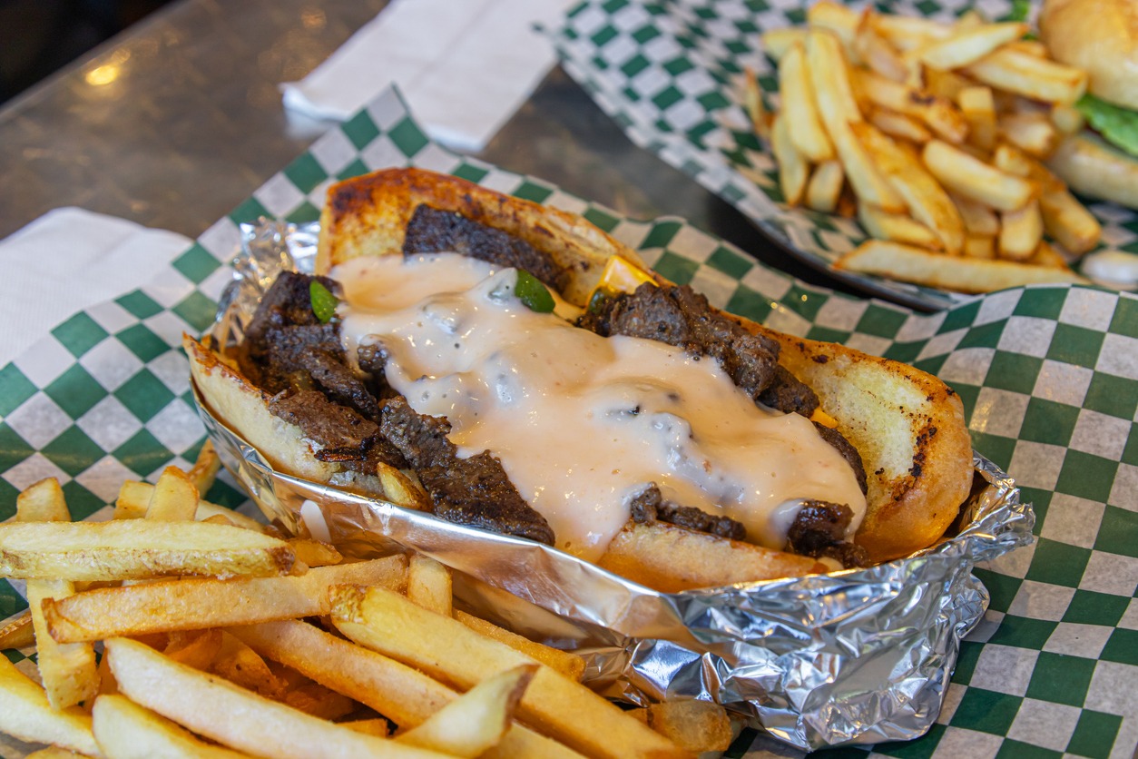 Philly cheesesteak sandwich and fries