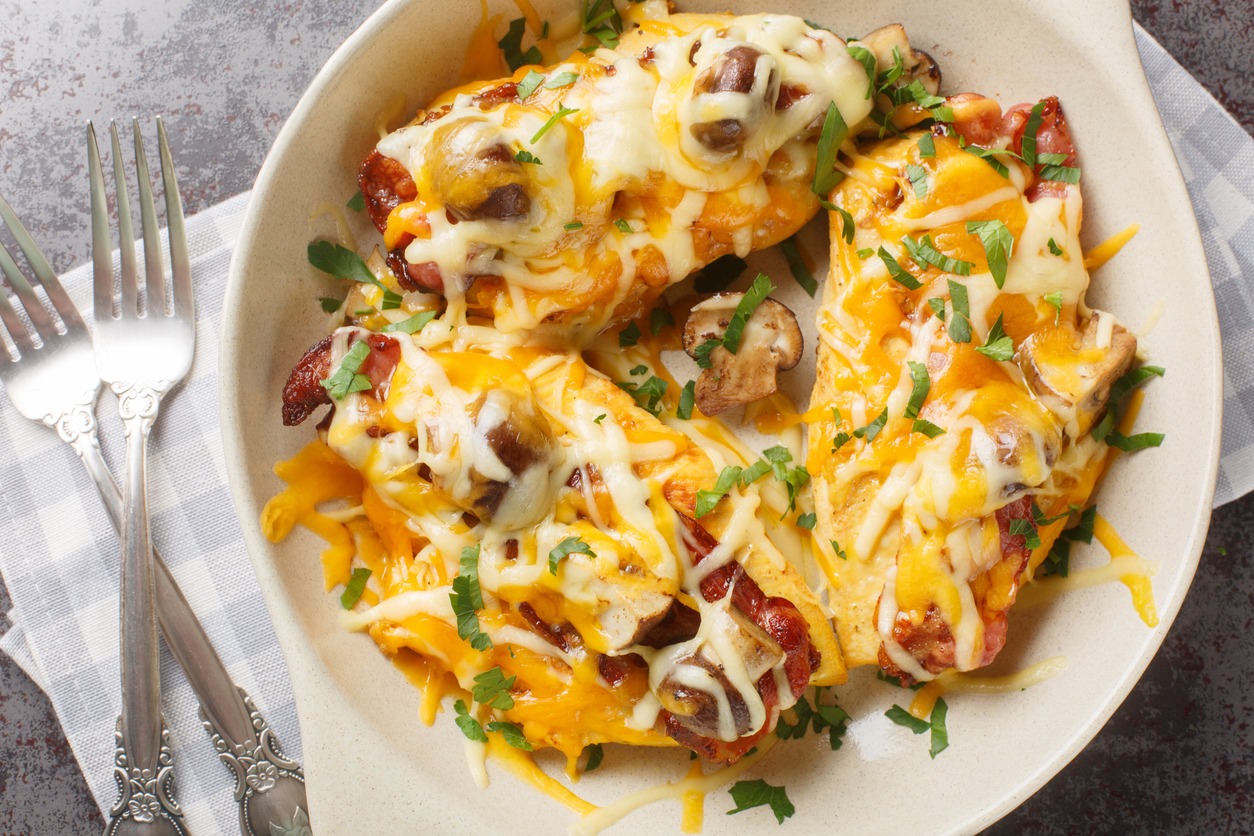 Chicken breasts are topped with a honey mustard sauce, bacon, cheese, and mushrooms