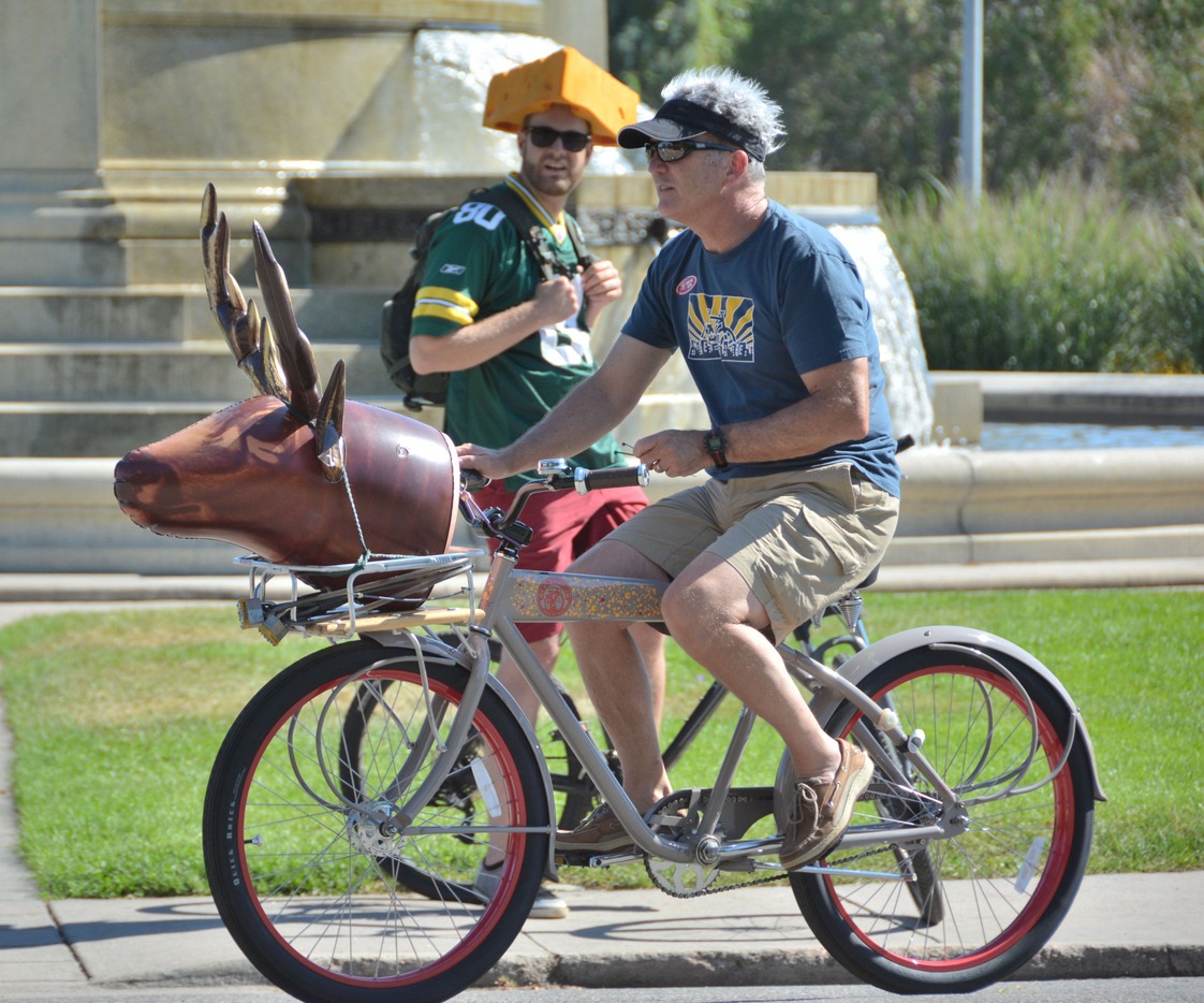 a biker with a man wearing cheesehead hat
