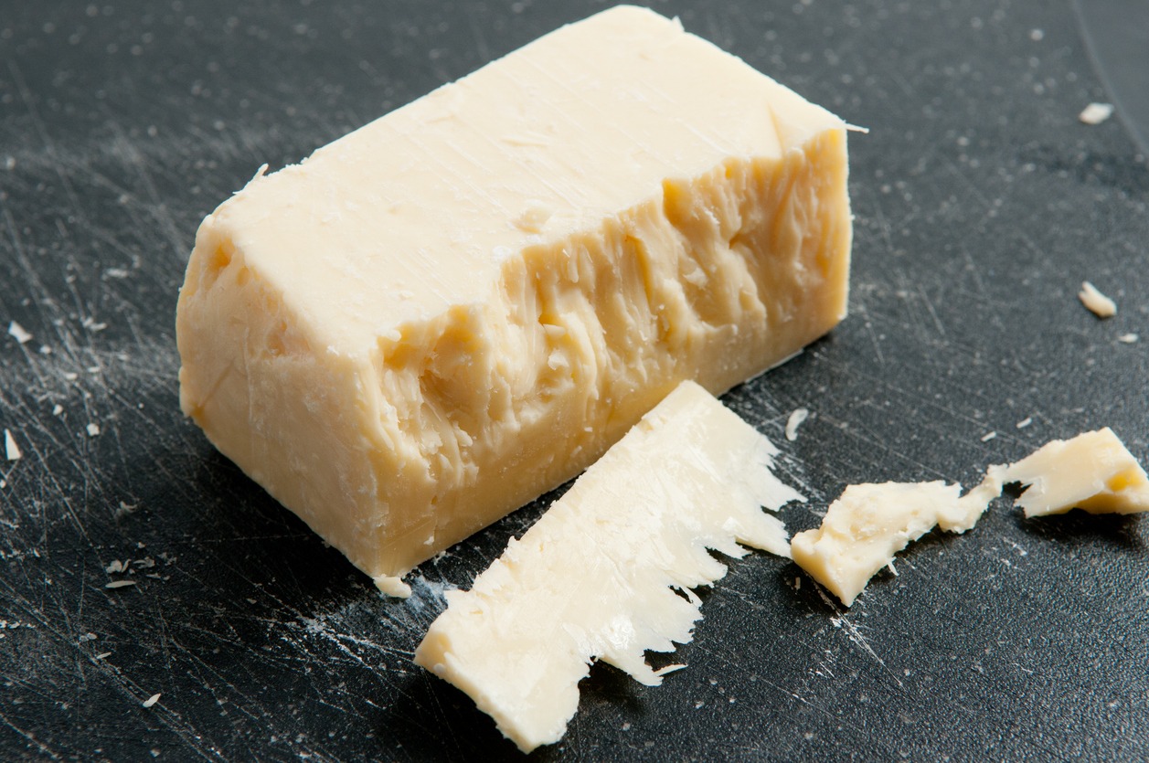 a block of aged white cheddar cheese