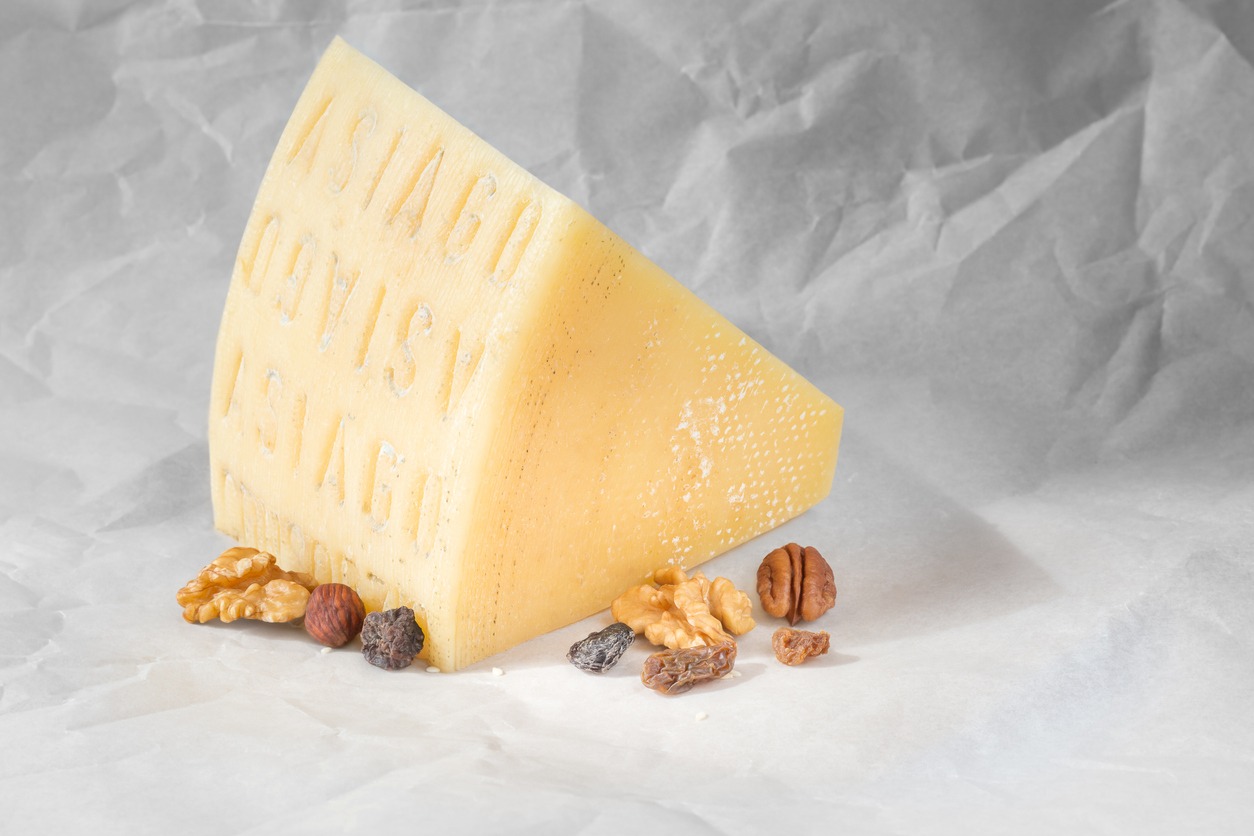 piece of Asiago cheese with nuts