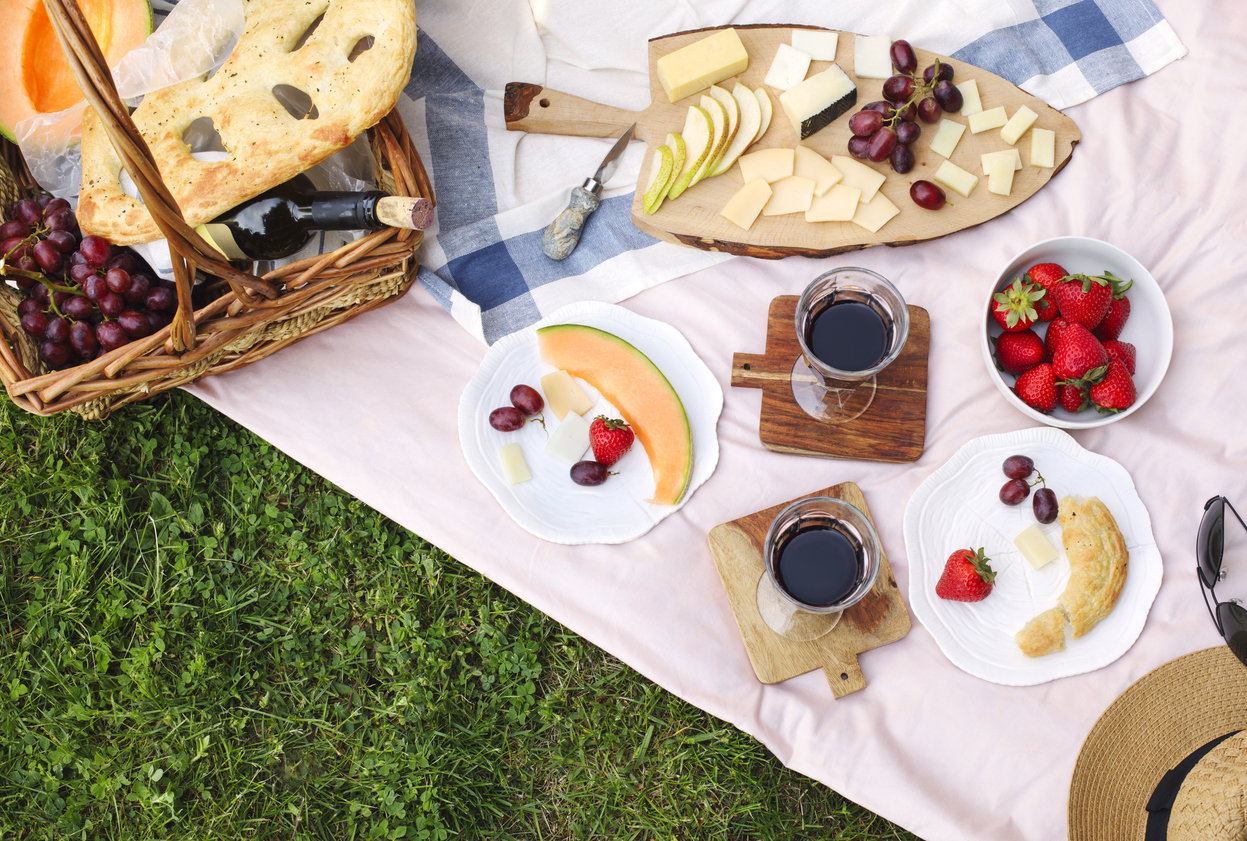 Summer picnic with cheese, wine, fruits and bread