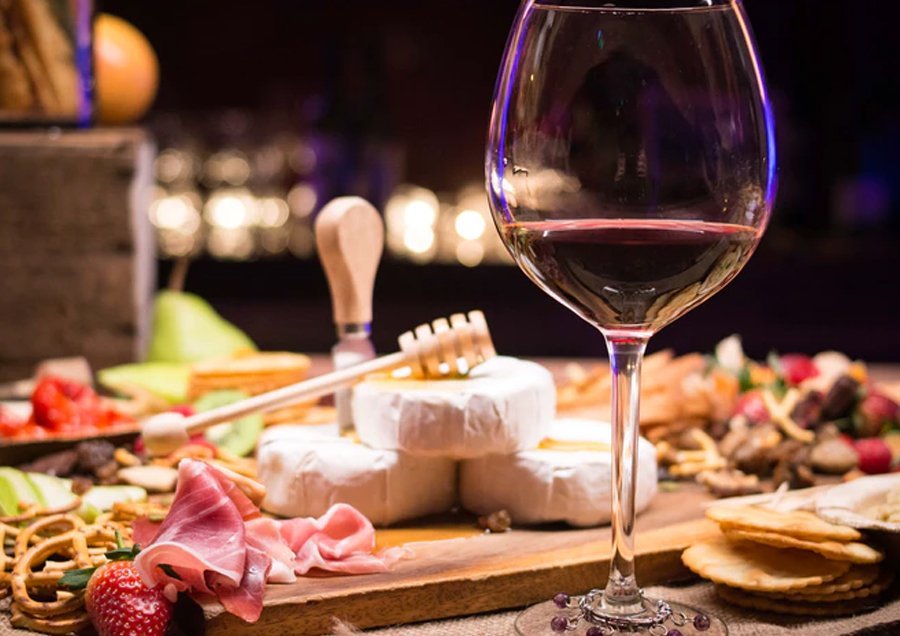 cheese board with a glass of wine
