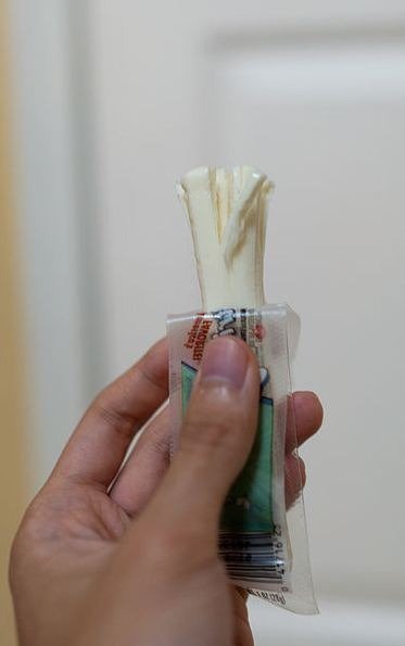 person holding a string cheese