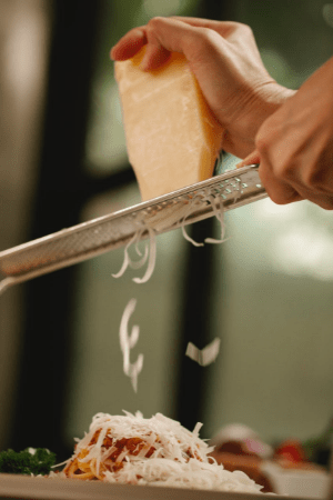 grating cheese on pasta