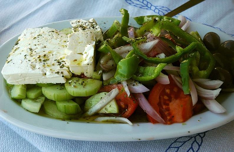 a Greek salad with a slice of feta